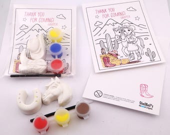 May include: A children's craft kit featuring a white cowboy hat, horseshoe, and horse head, with paint pots in red, yellow, blue, and brown. The kit includes a coloring page with the text "THANK YOU FOR COMING! HARPER".