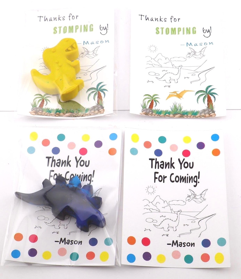 May include: Four small party favor bags. Two bags have yellow dinosaur crayons with the text "Thanks for STOMPING by!" and "-Mason". The other two bags have blue dinosaur crayons with the text "Thank You For Coming!" and "-Mason".