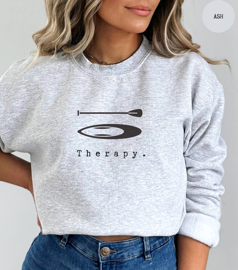 This ash sweatshirt has a black image of a sup board centred in the middle, with the word therapy underneath. Tailored towards people and couples who enjoy sup boarding also who find sup boarding a form of therapy.