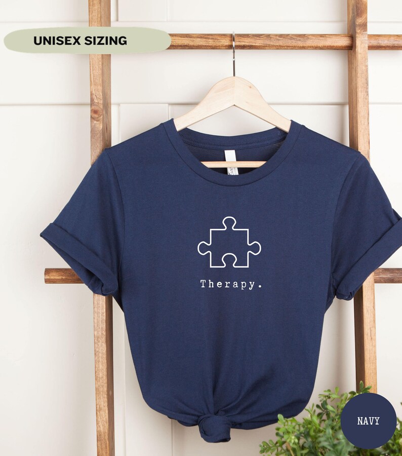 This navy t-shirt has a white image of a puzzle piece centred in the middle, with the word therapy underneath. Tailored towards people who enjoy puzzles also who find puzzles a form of therapy.