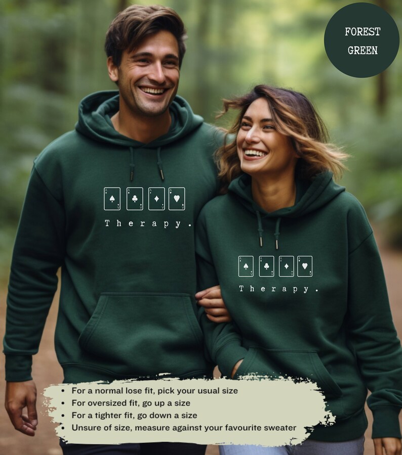 This forest green hoodie has a white image of playing cards centred in the middle, with the word therapy underneath. Tailored towards people and couples who enjoy playing cards games also who find playing card games a form of therapy.