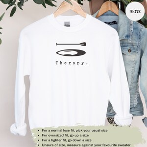 This white sweatshirt has a black image of a sup board centred in the middle, with the word therapy underneath. Tailored towards people and couples who enjoy sup boarding also who find sup boarding a form of therapy.