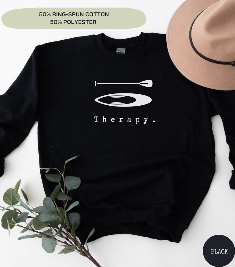 This black sweatshirt has a white image of a sup board centred in the middle, with the word therapy underneath. Tailored towards people and couples who enjoy sup boarding also who find sup boarding a form of therapy.