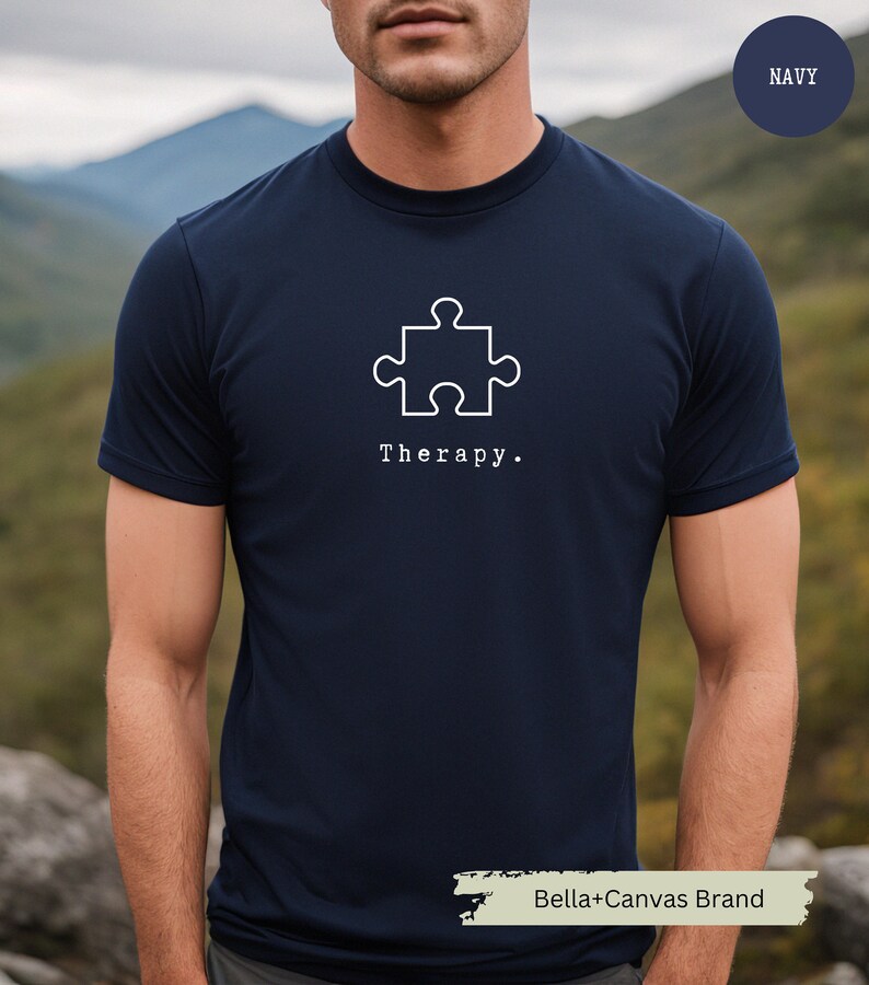 This navy t-shirt has a white image of a puzzle piece centred in the middle, with the word therapy underneath. Tailored towards people who enjoy puzzles also who find puzzles a form of therapy.