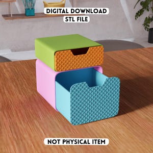 May include: A stack of two modular storage drawers with text reading DIGITAL DOWNLOAD STL FILE and NOT PHYSICAL ITEM. The top unit is lime green with an orange textured front, and the bottom unit is light pink with a blue textured front.