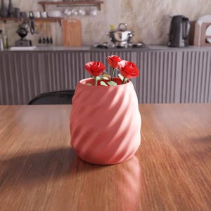 May include: A pink ceramic vase with a swirling pattern, holding a bouquet of red roses.
