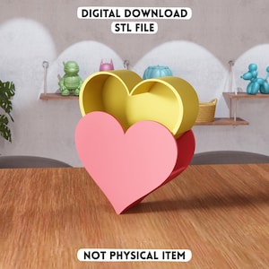 May include: A 3D-printed heart-shaped container in pink, yellow, and red. The container is open, revealing the interior. Text at the top reads "DIGITAL DOWNLOAD STL FILE", and at the bottom, "NOT PHYSICAL ITEM".