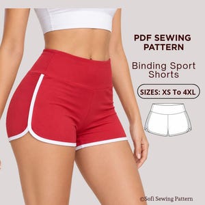 May include: Red athletic shorts with a high waistband and white trim along the curved leg openings. Text reads: PDF SEWING PATTERN, Binding Sport Shorts, SIZES: XS To 4XL, and Sofi Sewing Pattern. A line drawing of the shorts is also included.
