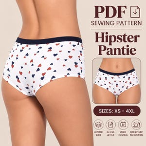 Puede incluir: Una braga tipo hipster blanca con un estampado de pequeños corazones rojos y azul marino y una cinturilla azul marino lisa. El texto dice PDF SEWING PATTERN, Hipster Pantie, SIZES: XS - 4XL, LAYERED SIZES, A4 / US LETTER, VIDEO TUTORIAL, STEP-BY-STEP INSTRUCTIONS.