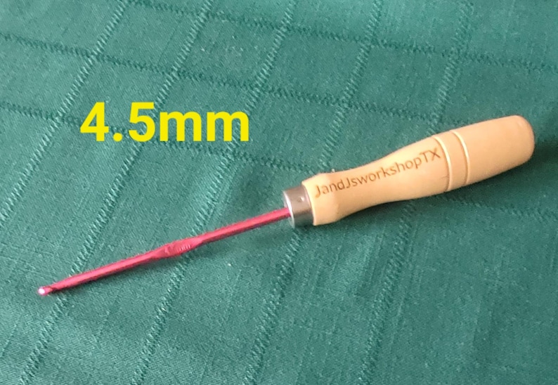May include: A 4.5 mm crochet hook with a wooden handle. The handle is engraved with "JandJworkshopTX".
