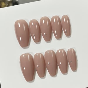 May include: A set of three ceramic mugs with a speckled, matte finish. The mugs are in shades of cream, light gray, and dark gray. Each mug has a simple, minimalist design, perfect for coffee or tea.