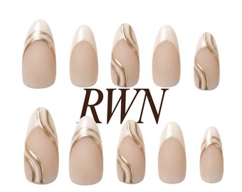 May include: A set of ten almond-shaped press-on nails featuring a nude base with white tips and gold swirl accents. The text RWN is centred between the rows, and the text Rich Wife's Nails by Pinneacle appears at the bottom with a logo above.