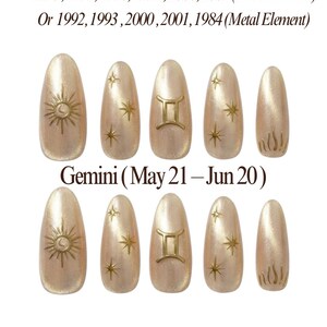 May include: Ten artificial nails with a light beige shimmer. Each nail has gold-coloured embellishments, including suns, stars, and the Gemini symbol. The image includes text with birth years, the Gemini zodiac sign, and the brand name.