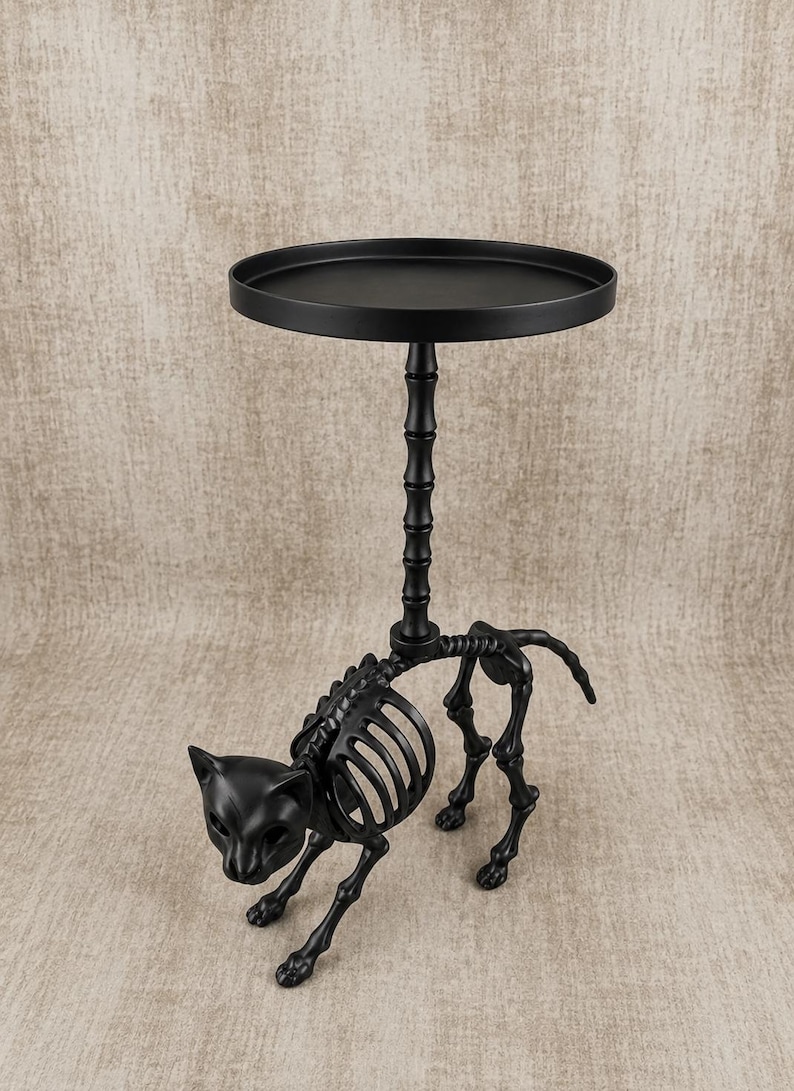 May include: A black metal side table with a cat skeleton design. The table has a round top and a decorative stem. The cat skeleton is in a walking pose, adding a unique touch to the Halloween-themed decor.