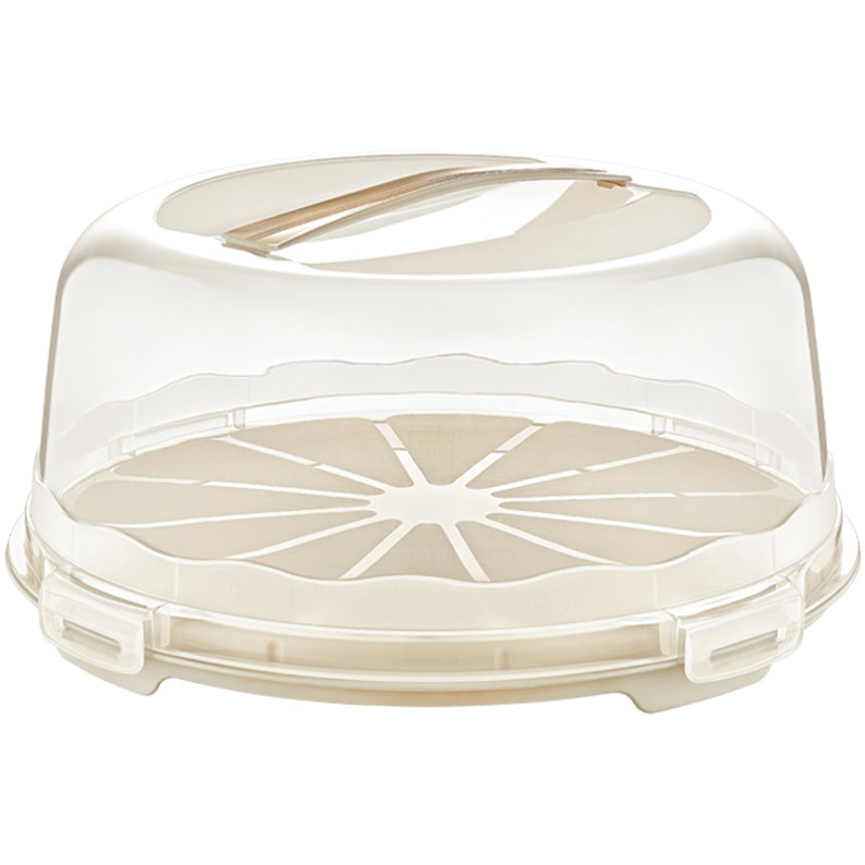 May include: A clear plastic cake carrier with a beige base and a removable lid. The lid has a handle and the base has a decorative pattern.