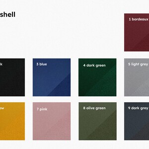 Pu&ograve; includere: Una tavolozza di colori con nove campioni numerati e denominati. I colori includono bordeaux, nero, blu, verde scuro, grigio chiaro, giallo, rosa, verde oliva e grigio scuro. La parola "softshell" &egrave; in alto.