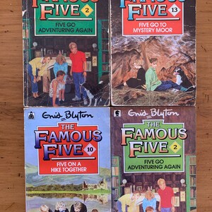 May include: Four paperback books with colorful covers featuring illustrations of children and a dog. The books are titled "The Famous Five" with different numbers and titles: "Five Go Adventuring Again", "Five Go to Mystery Moor", "Five On a Hike Together", and "Five Go Adventuring Again".
