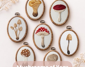 May include: A collection of seven embroidered mushroom art pieces in oval wooden frames. The mushrooms feature various colors and designs, including red, brown, and yellow. The text "Mushrooms of Year" is displayed on a pink banner.