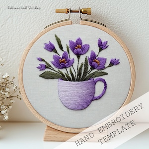 Satin Stitch Embroidery Pattern PDF Purple Crocus Mug Design DMC Thread Color Reference Stem Stitch Technique French Knot Stamen Detail Lazy Daisy Pointed Petal Method Padded Satin Crocus Volume Dense Solid Fill Lavender Cup Body Split Stitch Cup Outline Hoop Art Format Gold Metal Hoop Display Printable Template Instant Digital Download Full DMC Color Chart Step By Step Stitch Diagram Botanical Crocus Saffron Motif Violet Purple Olive Green Gold Orange Thread Palette Beginner Instructions
