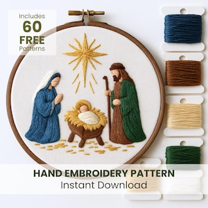 May include: An embroidery hoop with a nativity scene, featuring Mary, Joseph, and baby Jesus, stitched with blue, green, brown, and gold thread. The text "Includes 60 FREE Patterns" and "HAND EMBROIDERY PATTERN Instant Download" are visible. Spools of thread in various colours are also present.
