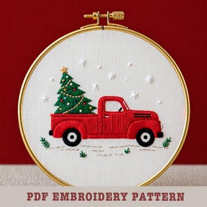 May include: Embroidered Christmas scene in a gold hoop. A red truck carries a green Christmas tree with a gold star. White snowflakes and greenery are also embroidered. The text "PDF EMBROIDERY PATTERN" is at the bottom.