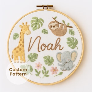May include: Embroidered hoop art featuring a giraffe, sloth, and elephant, with the name "Noah" in brown thread. Green leaves and pink flowers surround the animals. The text "Custom Pattern" is in a white circle at the bottom.