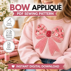 May include: A light pink sweatshirt featuring a large bow appliqué on the front. The bow has floral patterned fabric sections and solid pink fabric tails with visible white blanket stitching. Text reads BOW APPLIQUÉ PDF SEWING PATTERN.