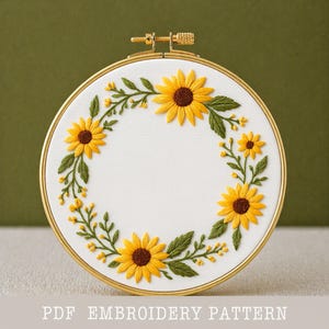 Sunflower Wreath Embroidery Pattern PDF Digital Download Summer Floral Hand Embroidery Template Sunflower Eucalyptus Needlework Project Botanical Hoop Art Yellow Sunflower Brown Center Motif Green Leaf Vine Design Satin Stitch Pattern DMC Color Chart Included Printable Embroidery Design Summer Wall Art Sunflower Botanical Wreath PDF Template Circular Wreath Olive Green Eucalyptus Yellow Bud Cluster Needlework Beginner Friendly Instructions DIY Wall Decor