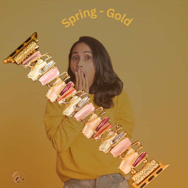 May include: A gold and multi-colored watch band with a spring-like design. The band is made of metal and has a variety of colored stones. The text "Spring - Gold" is written above the band.