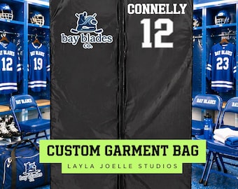 May include: Black custom garment bag with the text "CONNELLY 12" in white. The bag has a zipper closure and a handle opening. The "bay blades co." logo is on the bag. The text "CUSTOM GARMENT BAG" and "LAYLA JOELLE STUDIOS" are also visible.