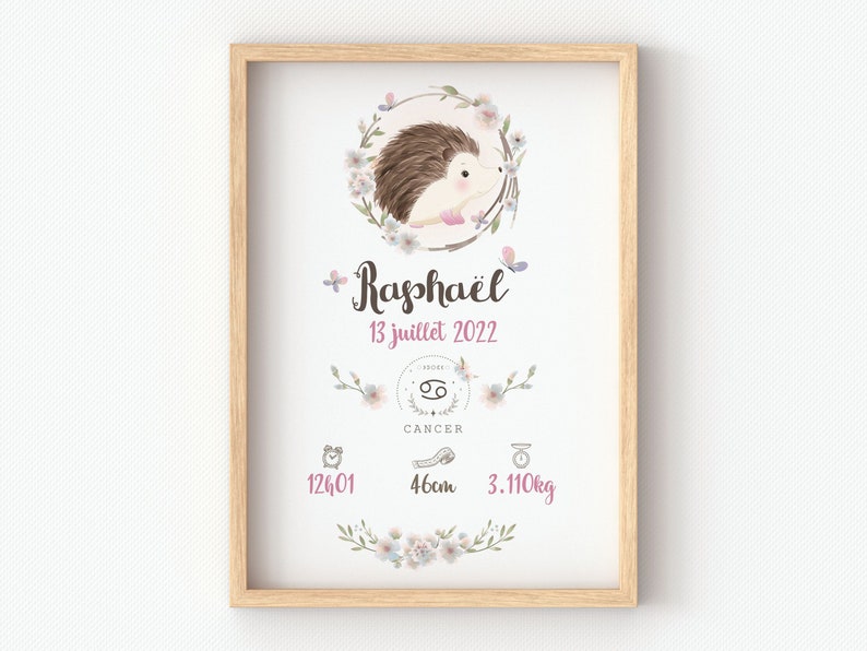 May include: A watercolor illustration of a hedgehog with a floral wreath around it. The illustration is in a light wood frame. The text on the illustration reads "Rapha&euml;l 13 juillet 2022 Cancer 12h01 46cm 3.110kg".