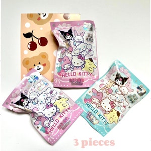 May include: Three Hello Kitty character eraser packs in pink, blue and white packaging. Each pack features a different Hello Kitty character design and the text "Hello Kitty Creative Erasers".