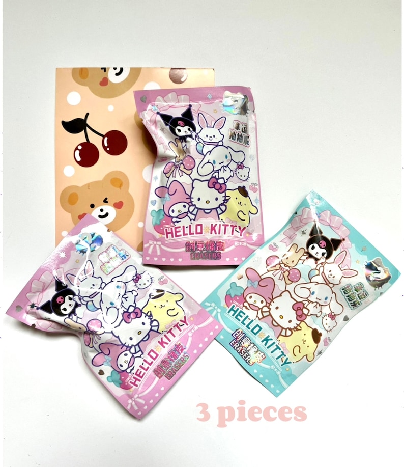 May include: Three Hello Kitty character eraser packs in pink, blue and white packaging. Each pack features a different Hello Kitty character design and the text "Hello Kitty Creative Erasers".