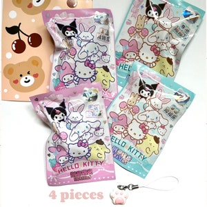 May include: Four pink and blue Hello Kitty themed bags of erasers with a Hello Kitty paw print charm. The bags have Chinese characters and the text "Hello Kitty Creative Erasers".