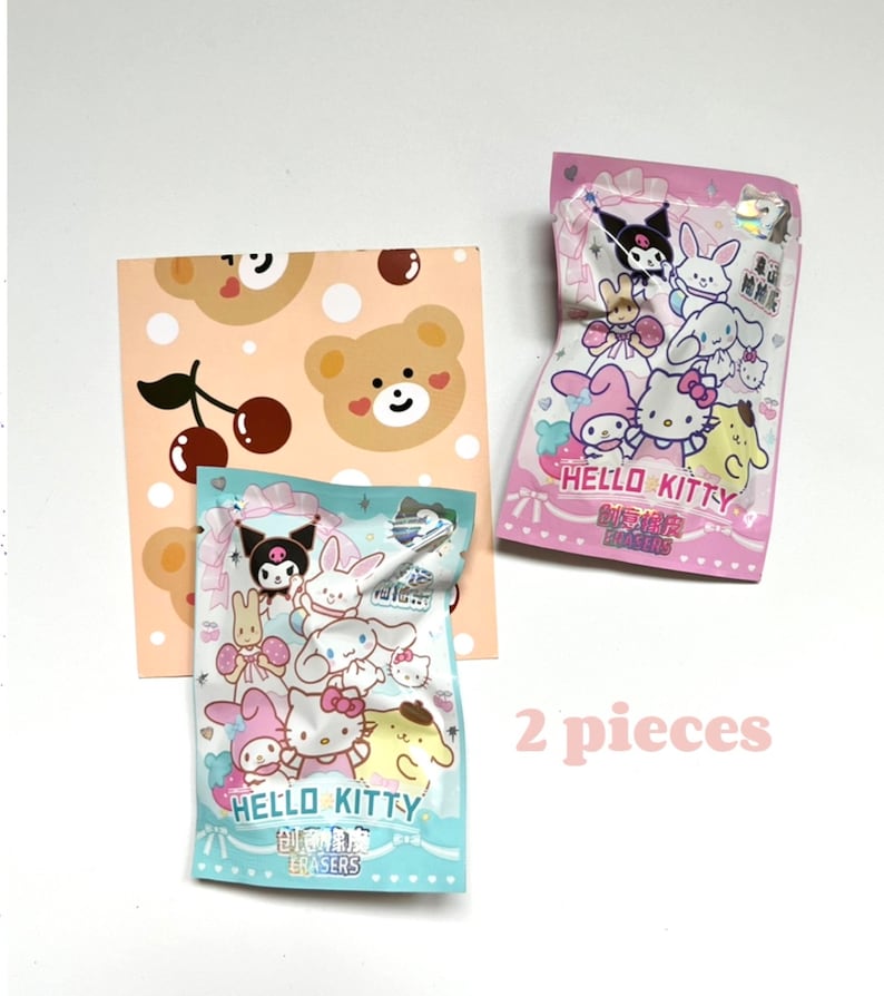 May include: Two packs of Hello Kitty erasers. One pack is pink with a Hello Kitty character and the other pack is blue with a Hello Kitty character. Both packs have a Hello Kitty logo and the text "Mini Erasers".