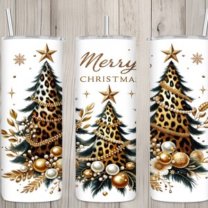May include: White tumbler with a Christmas tree design. The tree features a leopard print pattern, gold star, and pearl accents. The words "Merry Christmas" are displayed on the center tumbler. Includes a silver straw.