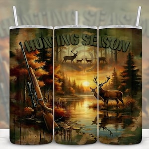 May include: A tumbler with a hunting theme, featuring a rifle, deer, and the words "Hunting Season." The design includes a forest scene with a sunset, trees, and a lake, with a straw.