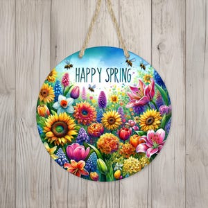 May include: A round wooden sign with a colorful floral design and the text "Happy Spring". The sign is decorated with bees, flowers, and leaves in shades of pink, purple, yellow, blue, and green.