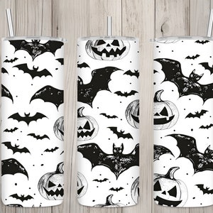 May include: Three black and white stainless steel tumblers with a Halloween theme. The tumblers feature a repeating pattern of bats and jack-o'-lanterns.