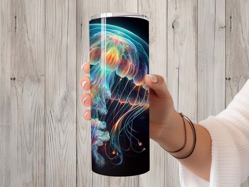 May include: A stainless steel tumbler featuring a colourful abstract jellyfish design. The jellyfish is a vibrant mix of blue, green, orange, and yellow.