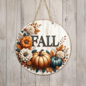 Könnte beinhalten: Ein rundes Holzschild mit dem Wort "FALL" in schwarzen Buchstaben, umgeben von einem Kranz aus herbstlichen Blumen, Kürbissen und Blättern.