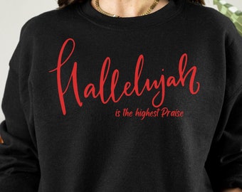 May include: Black sweatshirt with red lettering that says "Hallelujah is the highest Praise".