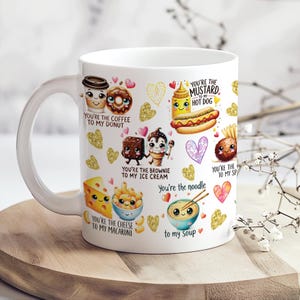 May include: White ceramic mug featuring cartoon food pairings with text like "You're the coffee to my donut" and "You're the mustard to my hot dog." Gold glitter hearts and other food illustrations decorate the mug.