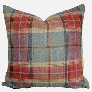 May include: A square throw pillow with a plaid pattern in shades of blue, red, beige, and brown.