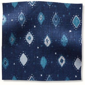 May include: A square of navy blue fabric with a repeating pattern of diamond shapes in shades of teal and white. The diamonds are outlined with small white dots, creating a textured appearance. The fabric has a slightly rough, woven texture.