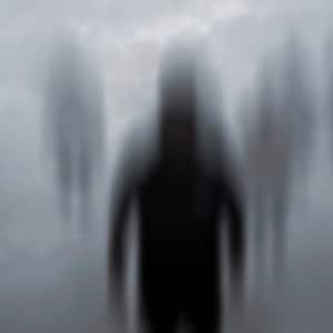 May include: A blurry image of several figures standing in a foggy, gray environment. The figures are out of focus and appear to be moving.