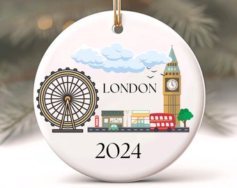 May include: White ceramic Christmas ornament with a colorful illustration of London landmarks, including the London Eye, Big Ben, and a double-decker bus. The ornament also includes the text "LONDON" and "2024".
