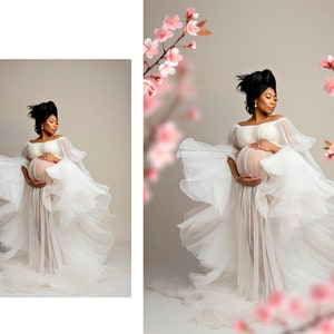 May include: A pregnant woman in a white flowing gown with a sheer overlay, standing in front of a light brown background with pink flowers on either side.