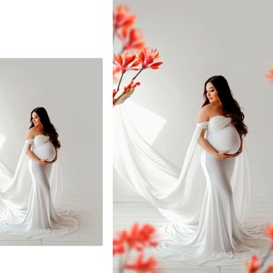 May include: A pregnant woman in a white off-the-shoulder gown with a flowing train, standing in a white studio with a white backdrop. She is holding her belly and looking down.