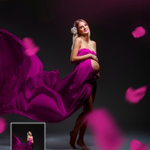 May include: A pregnant person stands draped in a flowing magenta fabric, with a white flower in their hair. The fabric billows around them, and magenta petals float in the air against a dark background. A small inset image is in the lower left corner.